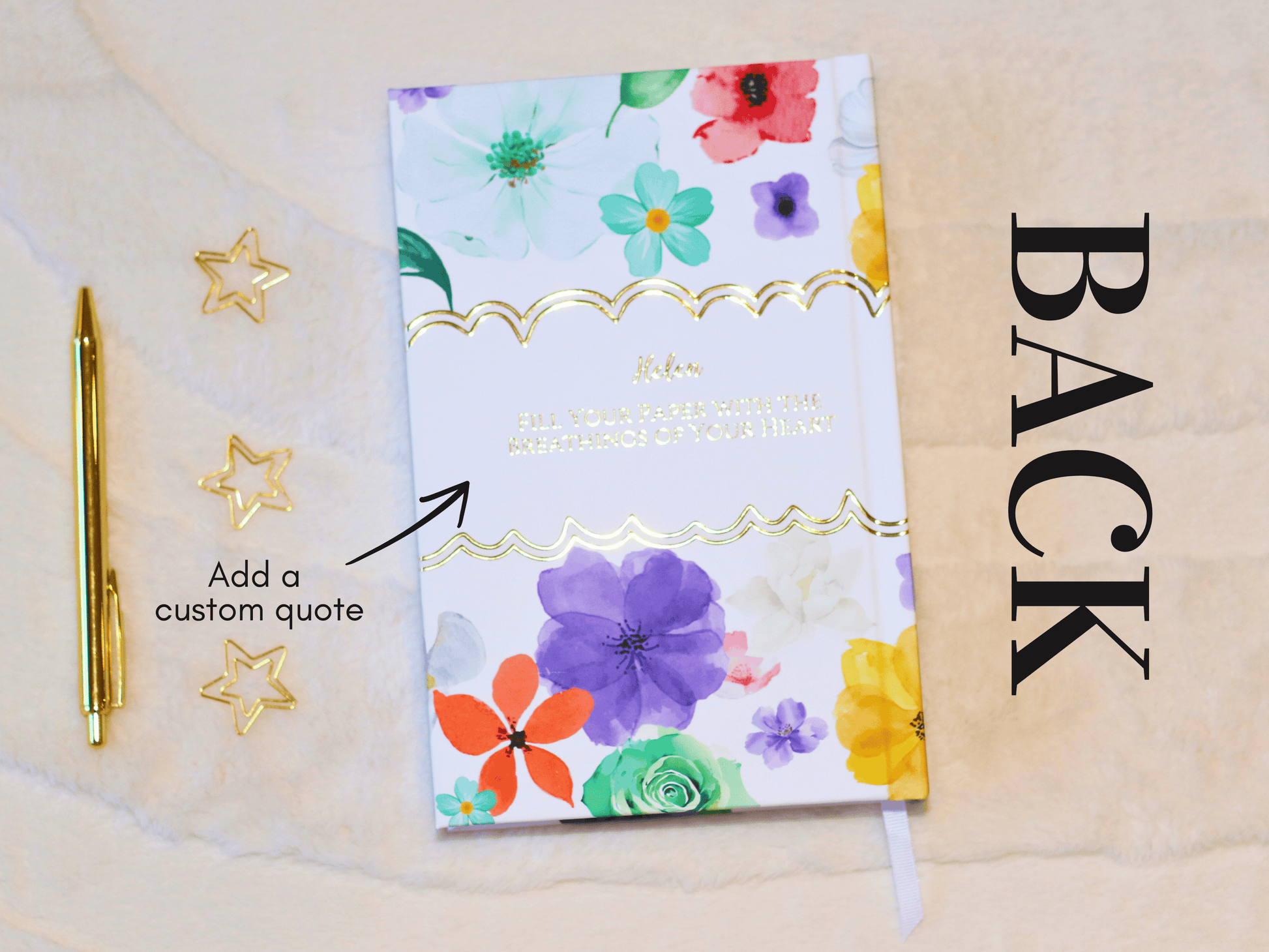 Floral notebook with a pen and decorative stars on a beige background