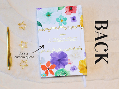 Floral notebook with a pen and decorative stars on a beige background