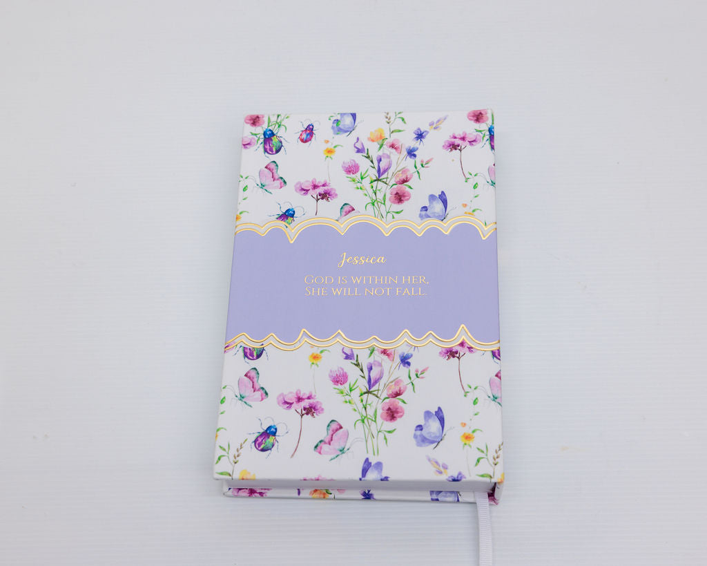 Decorative notebook with floral design and text on a white background